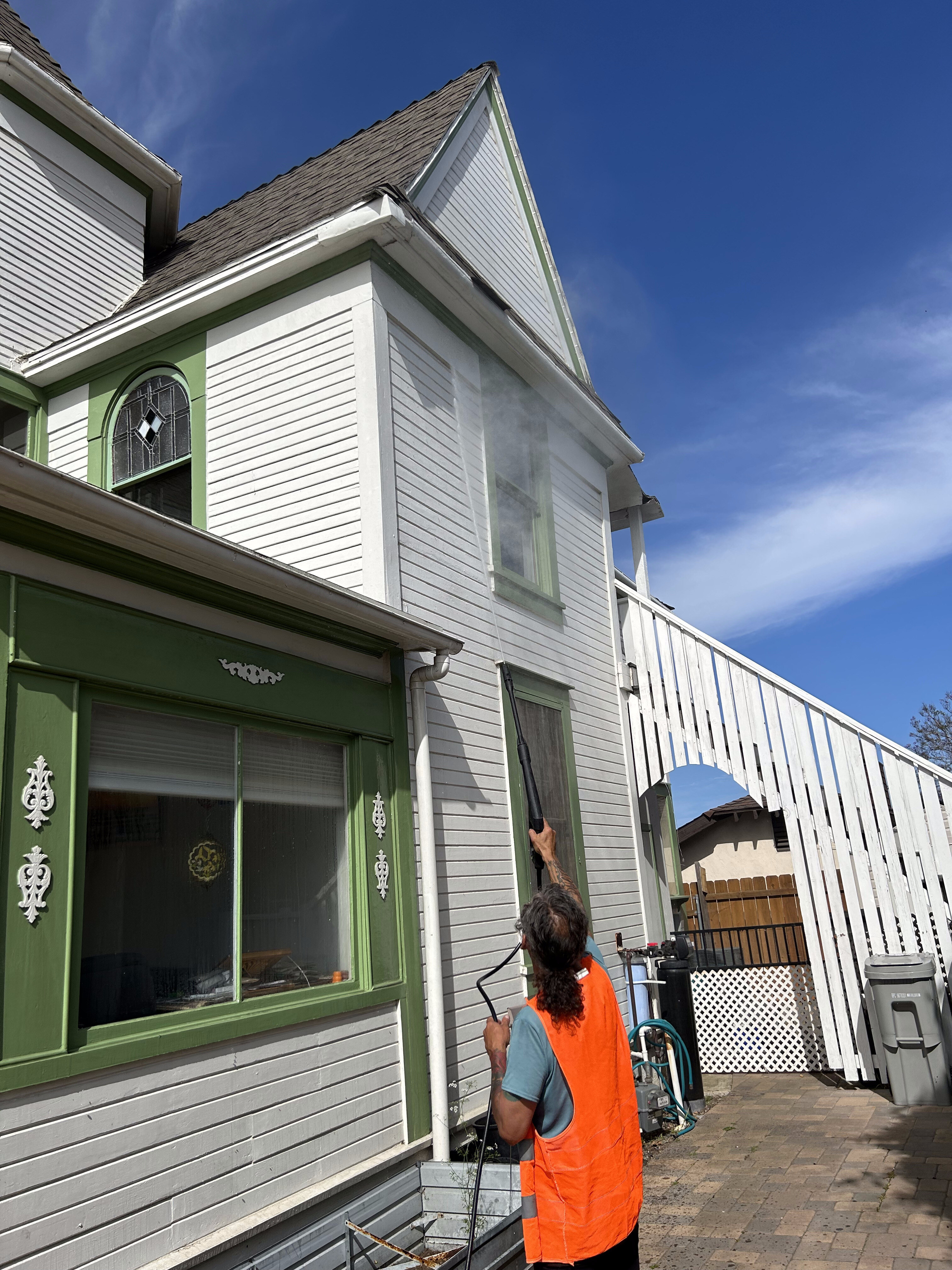 Pressure washing a home's exterior siding