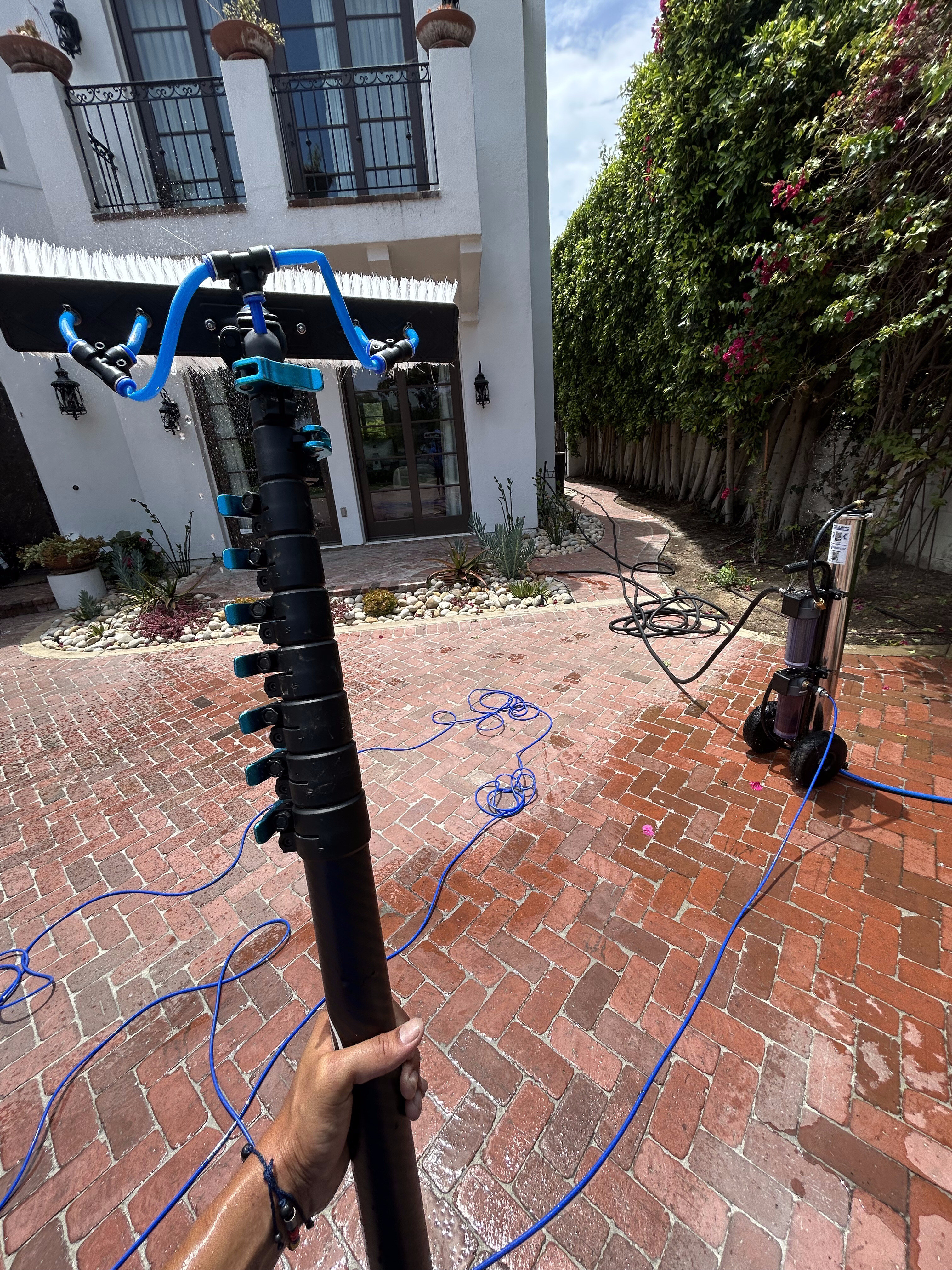 Water-fed pole window cleaning at a courtyard home